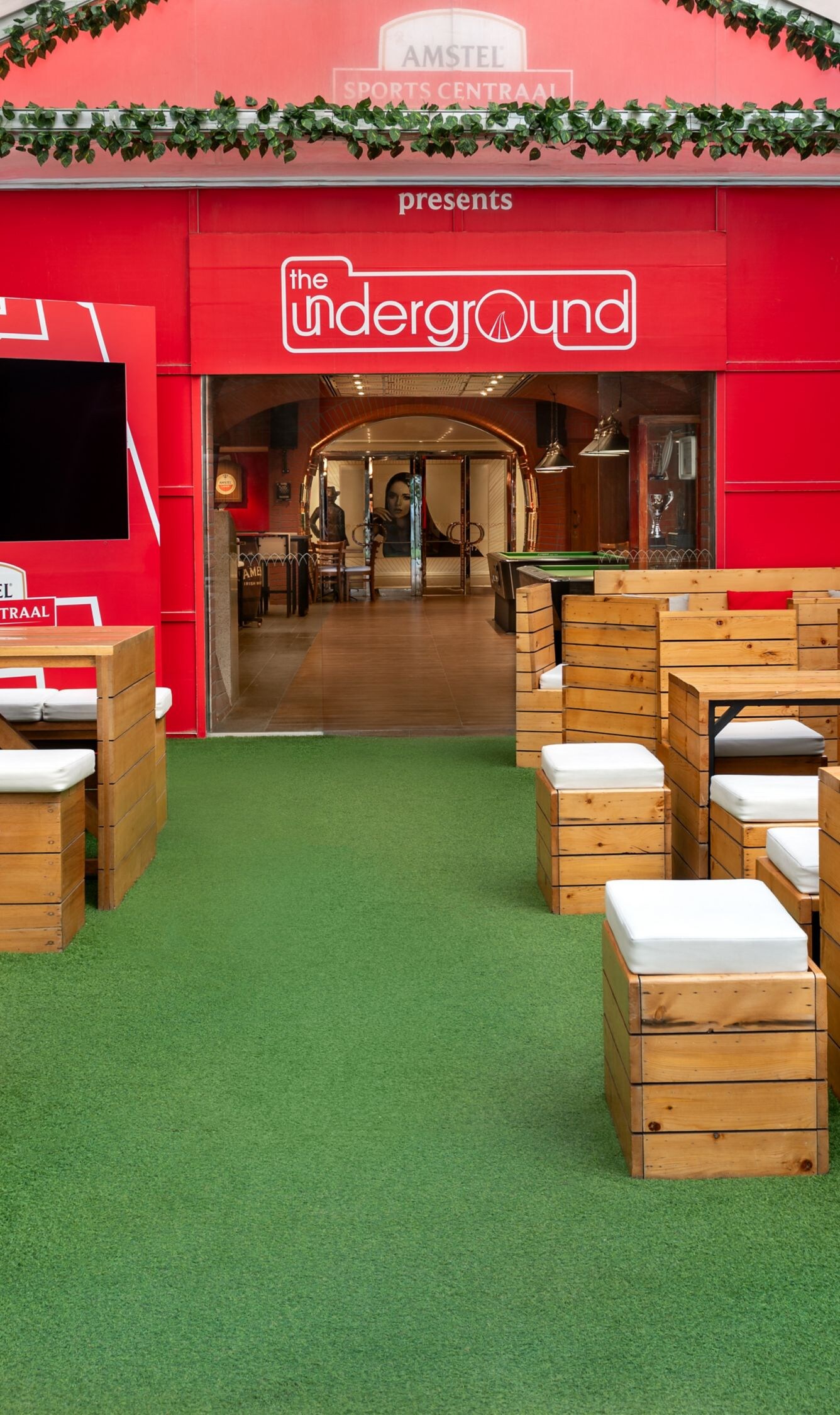 Outdoor pub seating area with sports décor