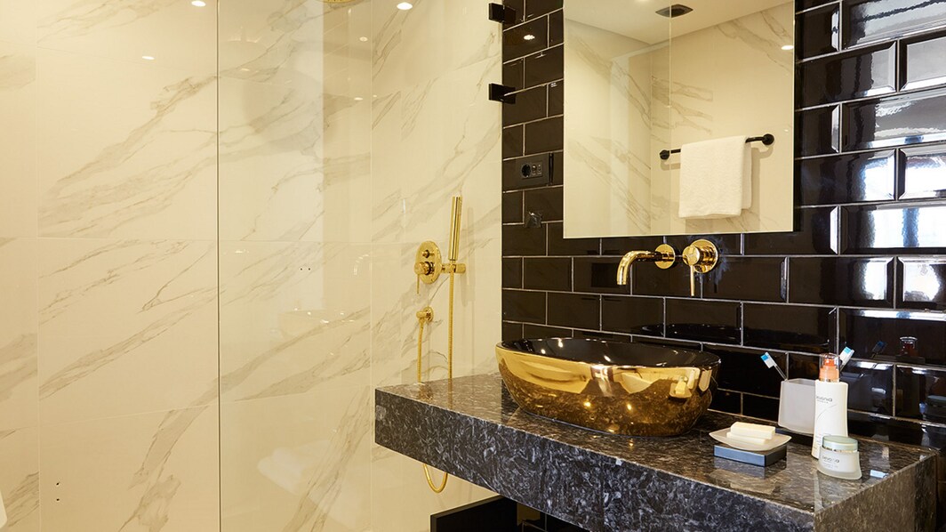 bathroom detail with gold sink
