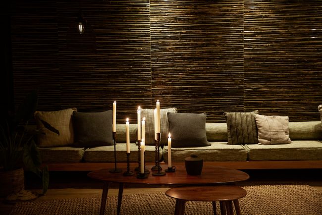 extended sofa in lobby with lit candles on table