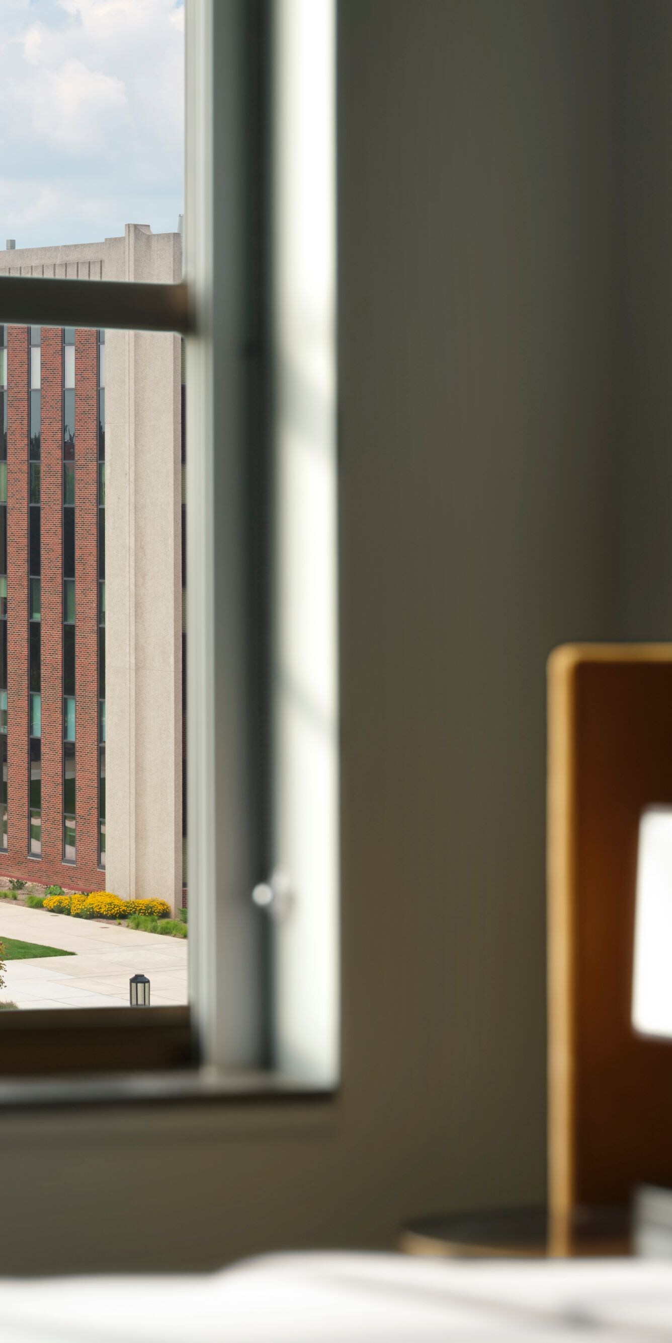 Bed beside window overlooking campus