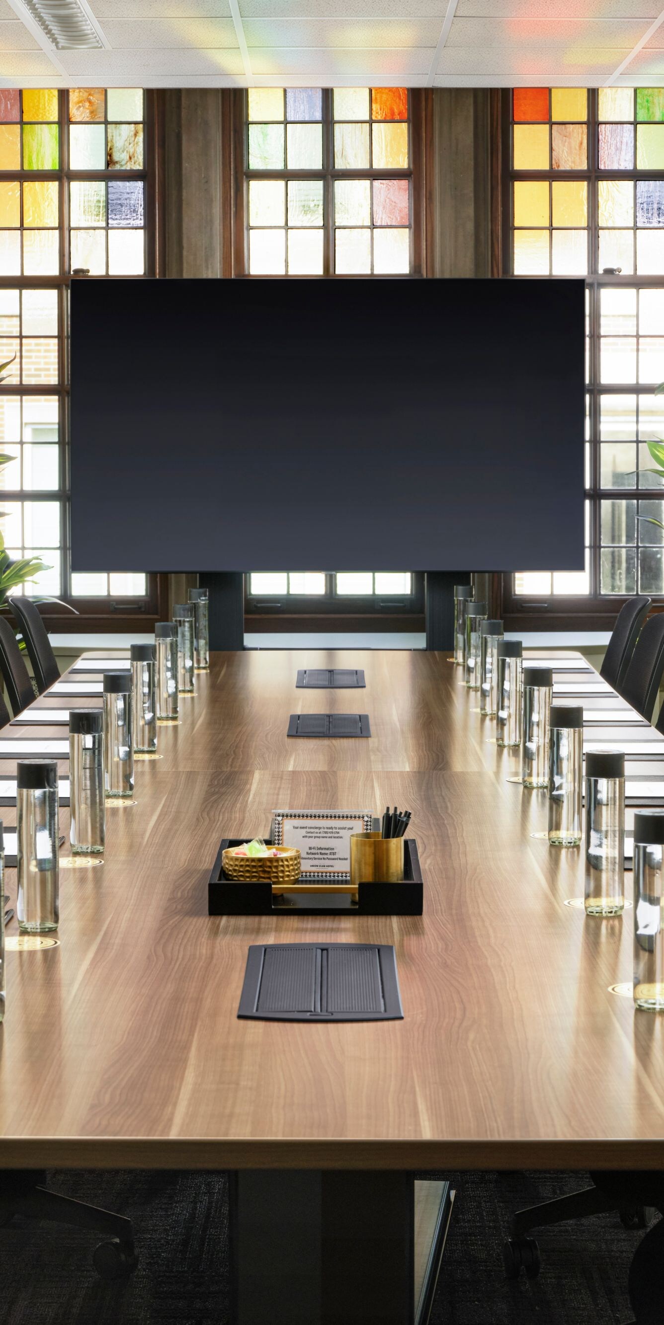 Long conference table facing screen