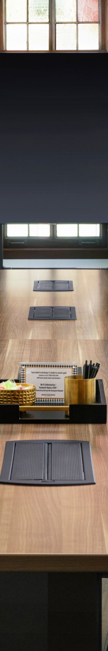 Long conference table facing screen
