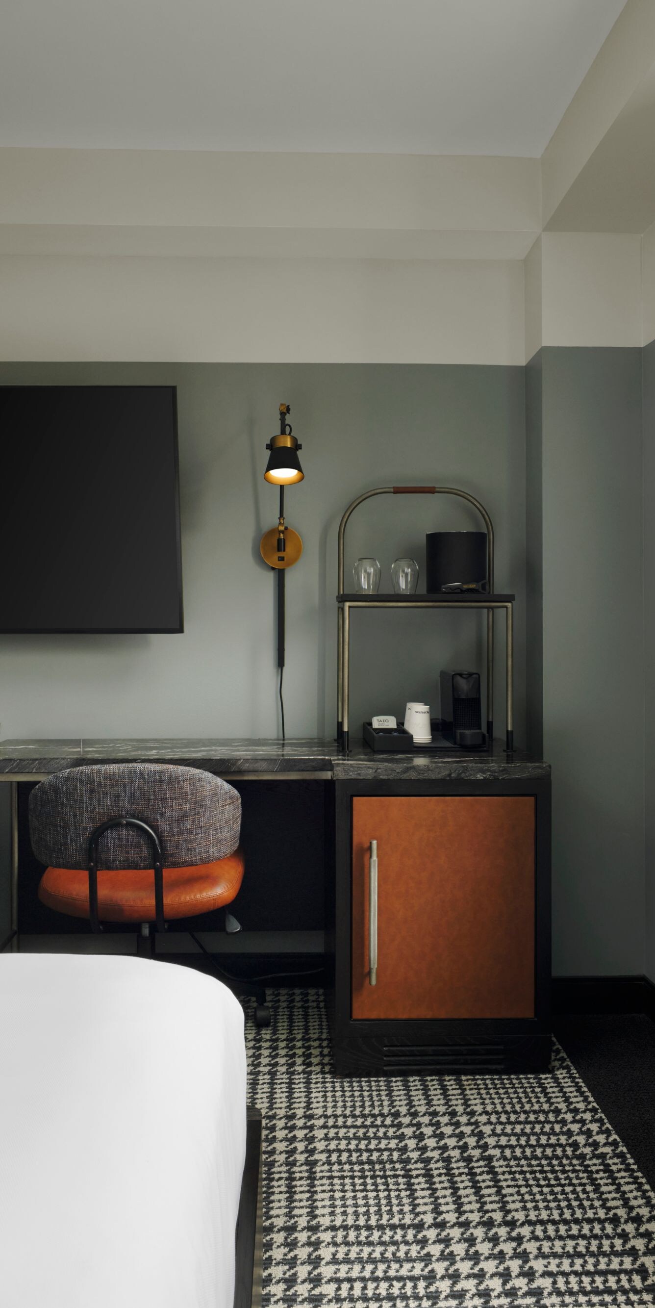 suite with desk and TV