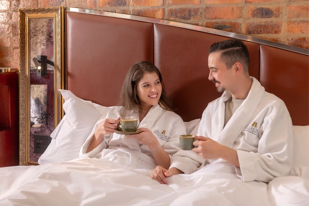 A couple enjoying coffee in bed  