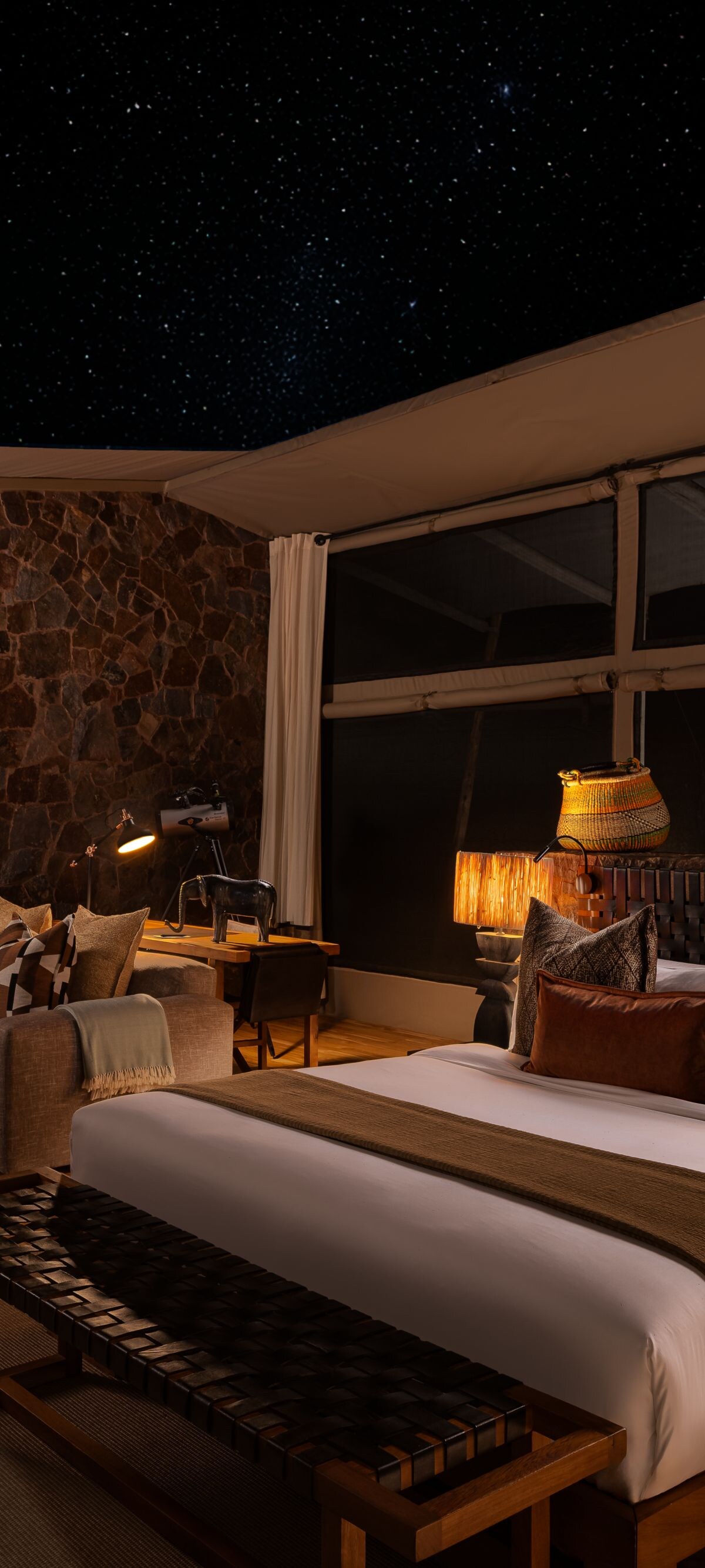Deluxe safari tent interior beneath an open star-f
