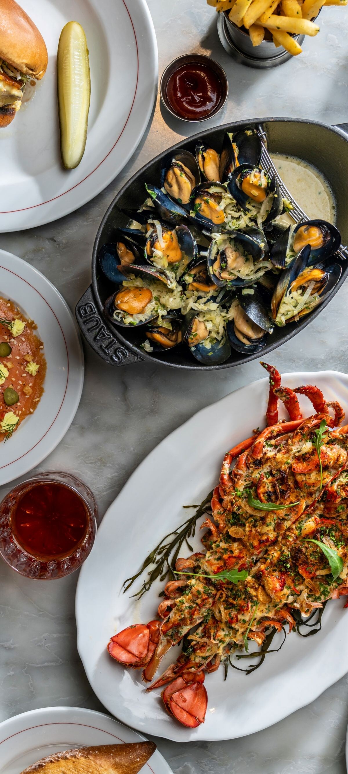 Various different food dishes on platters, plates
