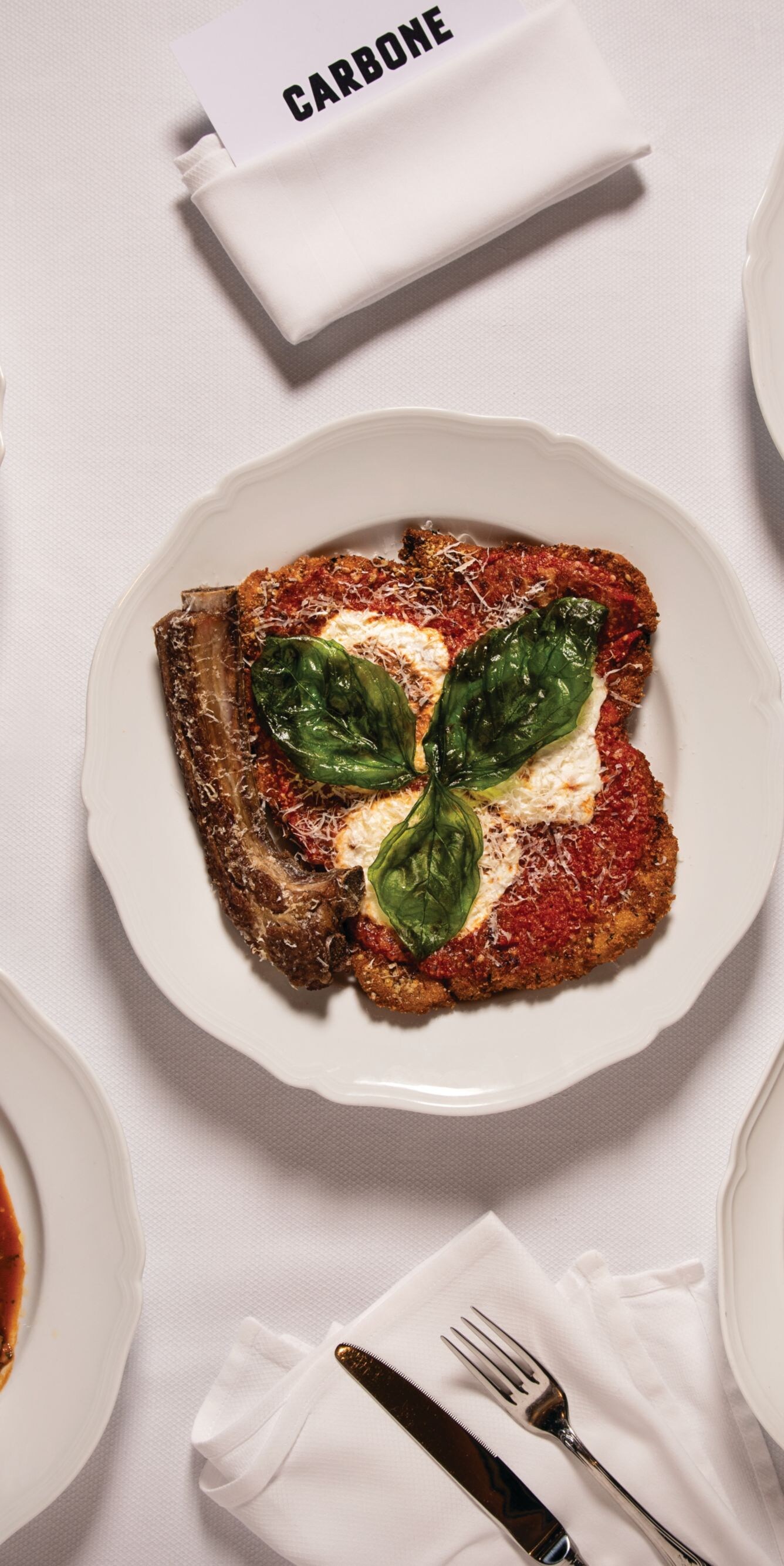 Assortment of Italian dishes on white platters.