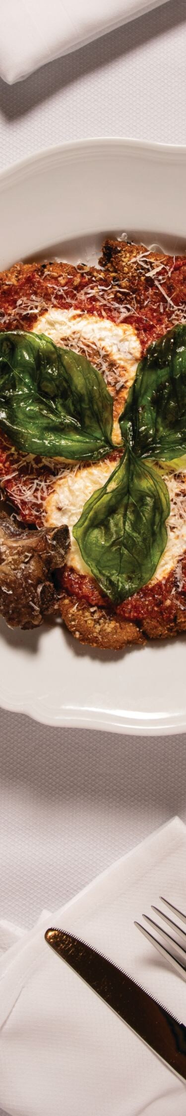 Assortment of Italian dishes on white platters.