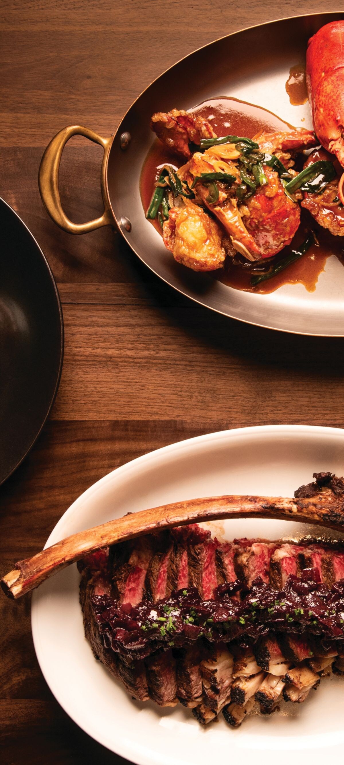 Steak, lobster dishes on platters
