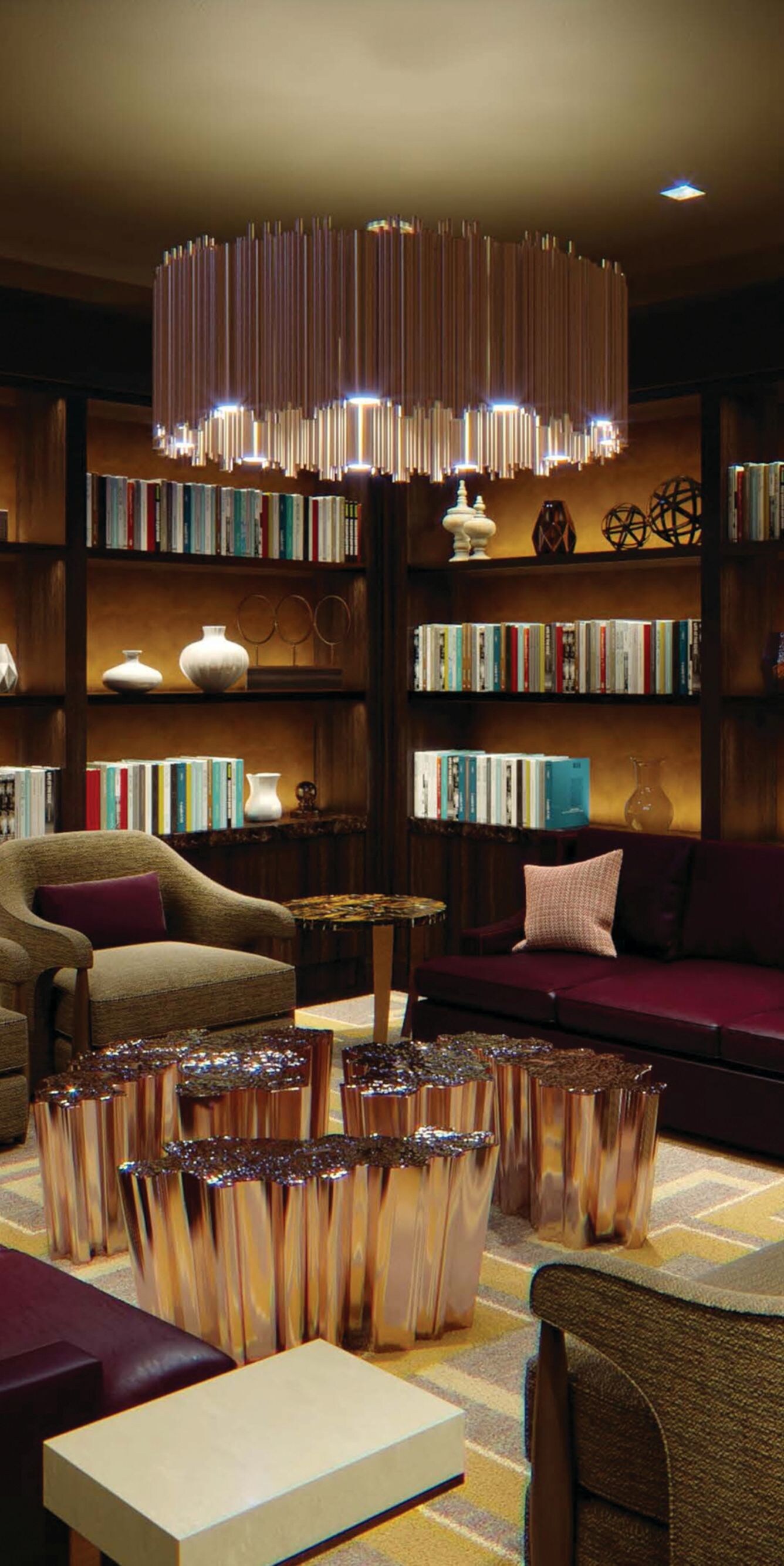 Chairs, sofa surrounded by bookshelves with books.