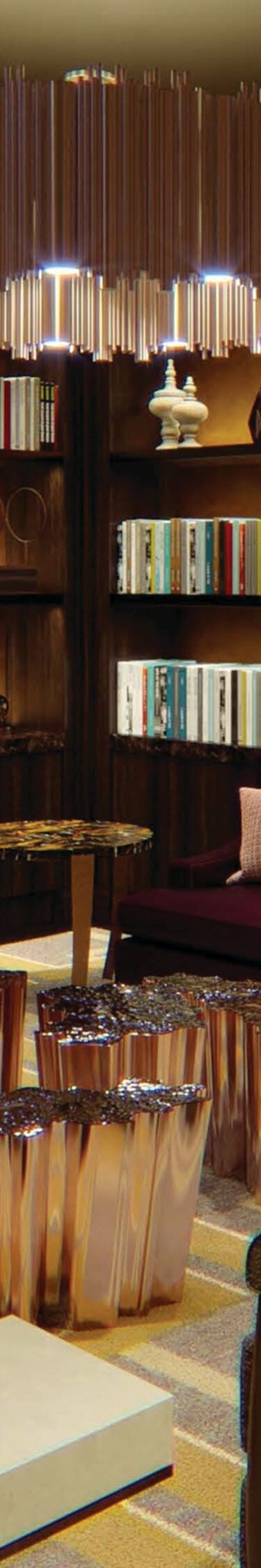 Chairs, sofa surrounded by bookshelves with books.