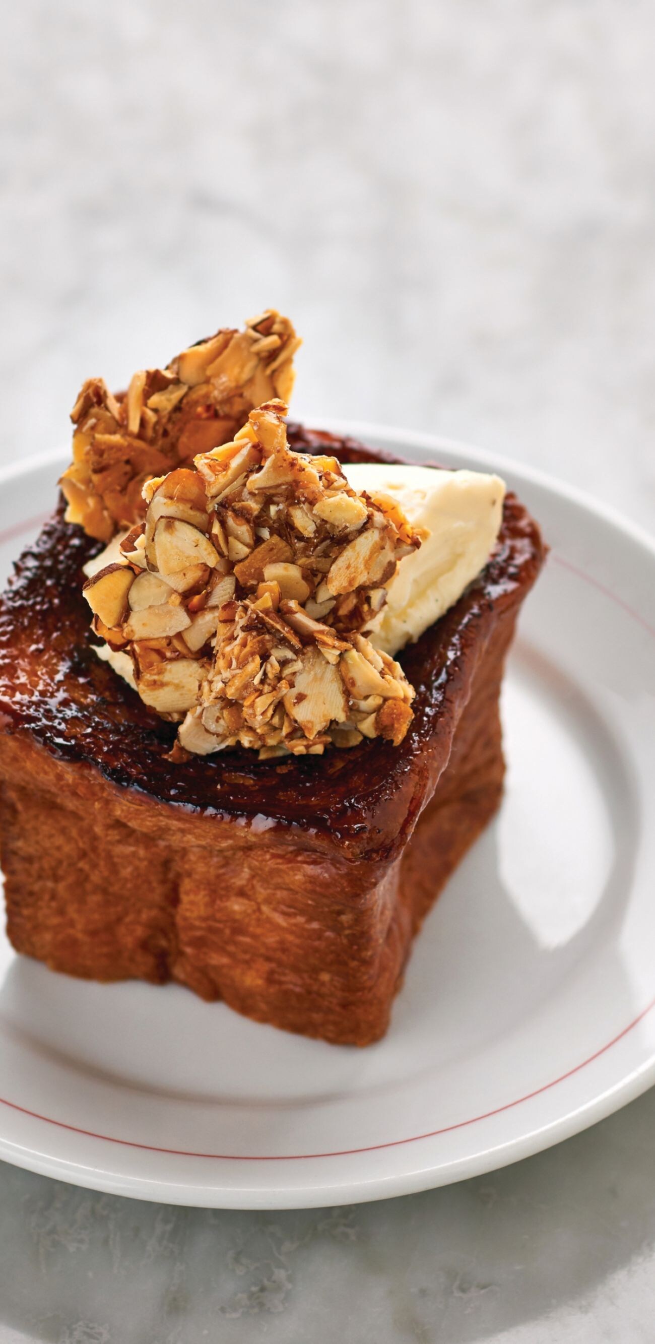 French toast with butter, nuts, syrup on the side
