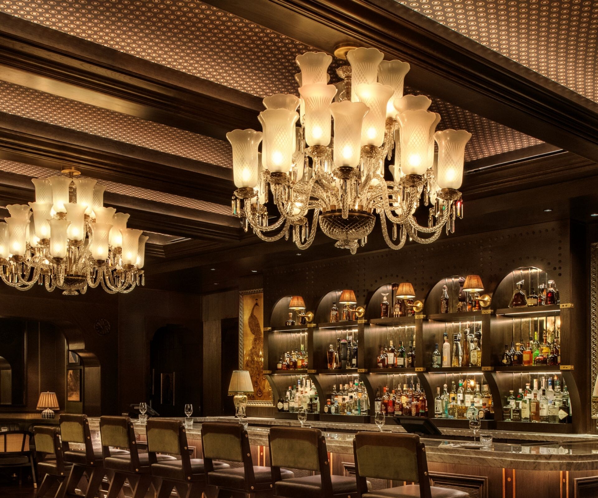 Two-top tables across from bar seating.