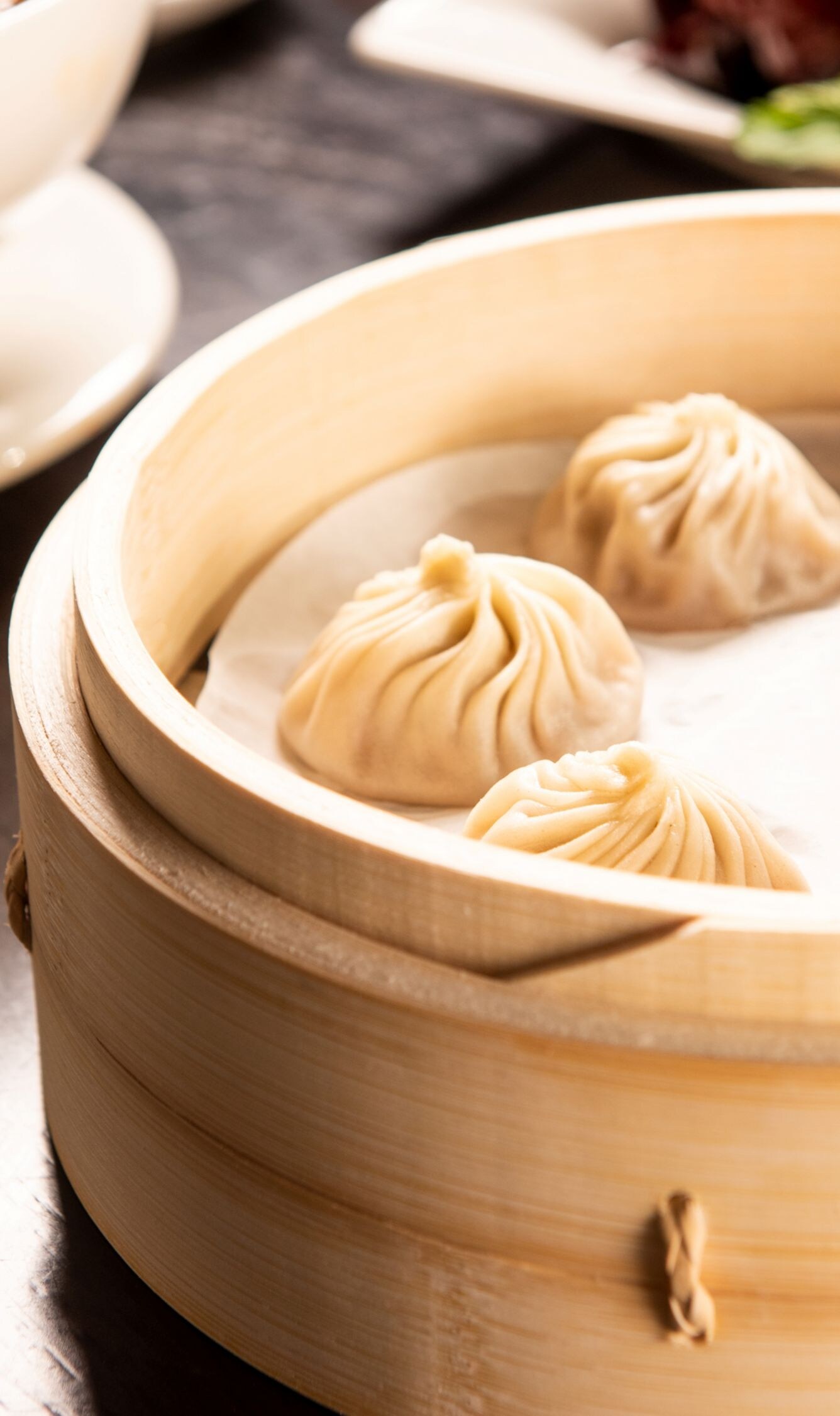 Soup dumplings, bowl of noodles, other food