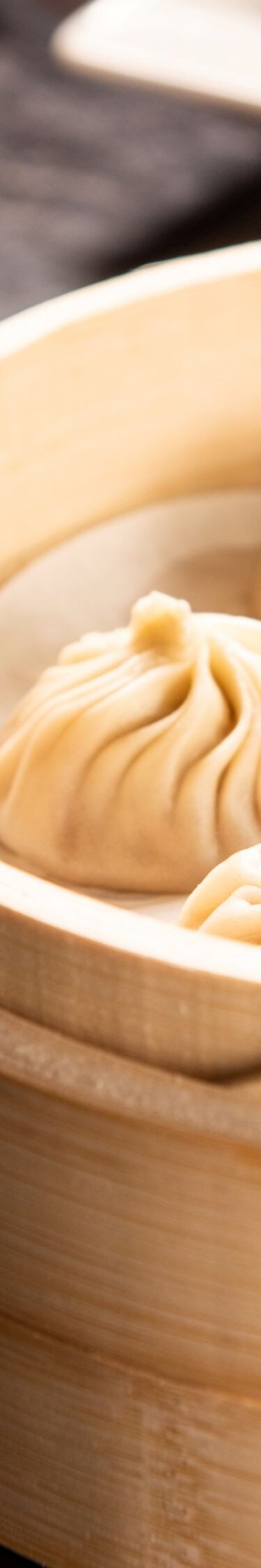 Soup dumplings, bowl of noodles, other food