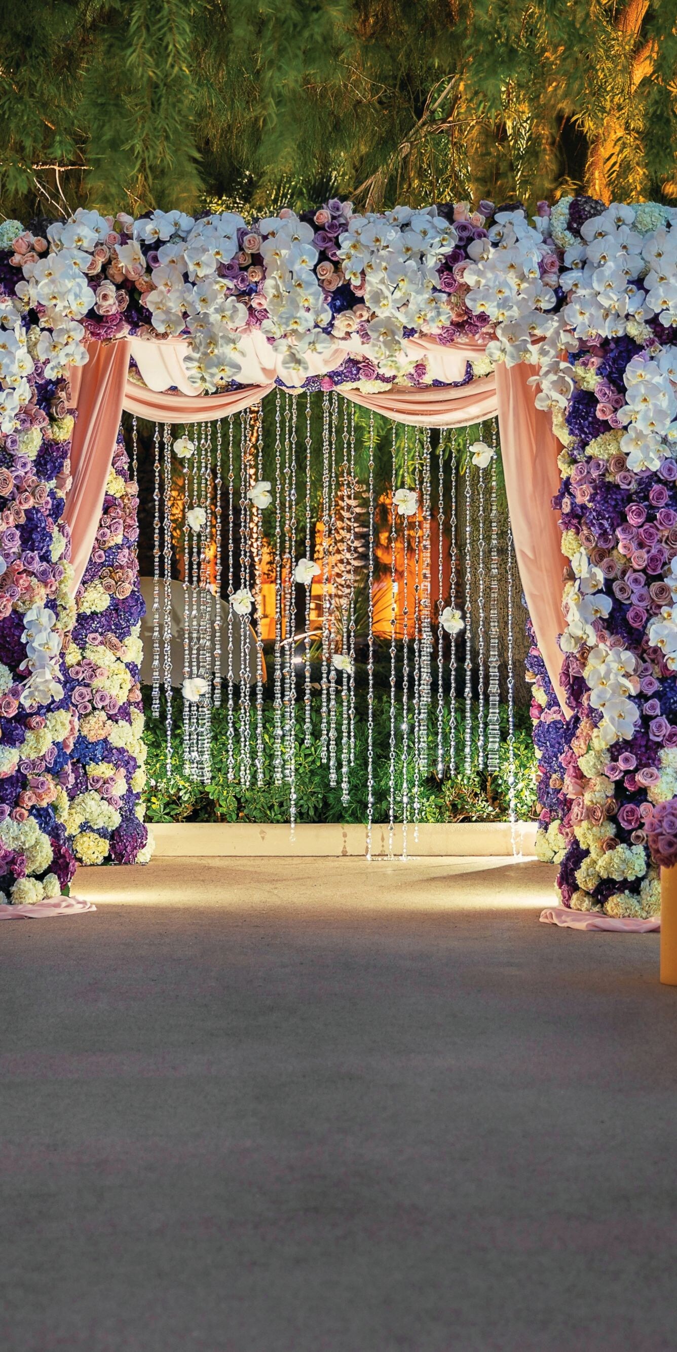 Flower archway, chairs, pillars.