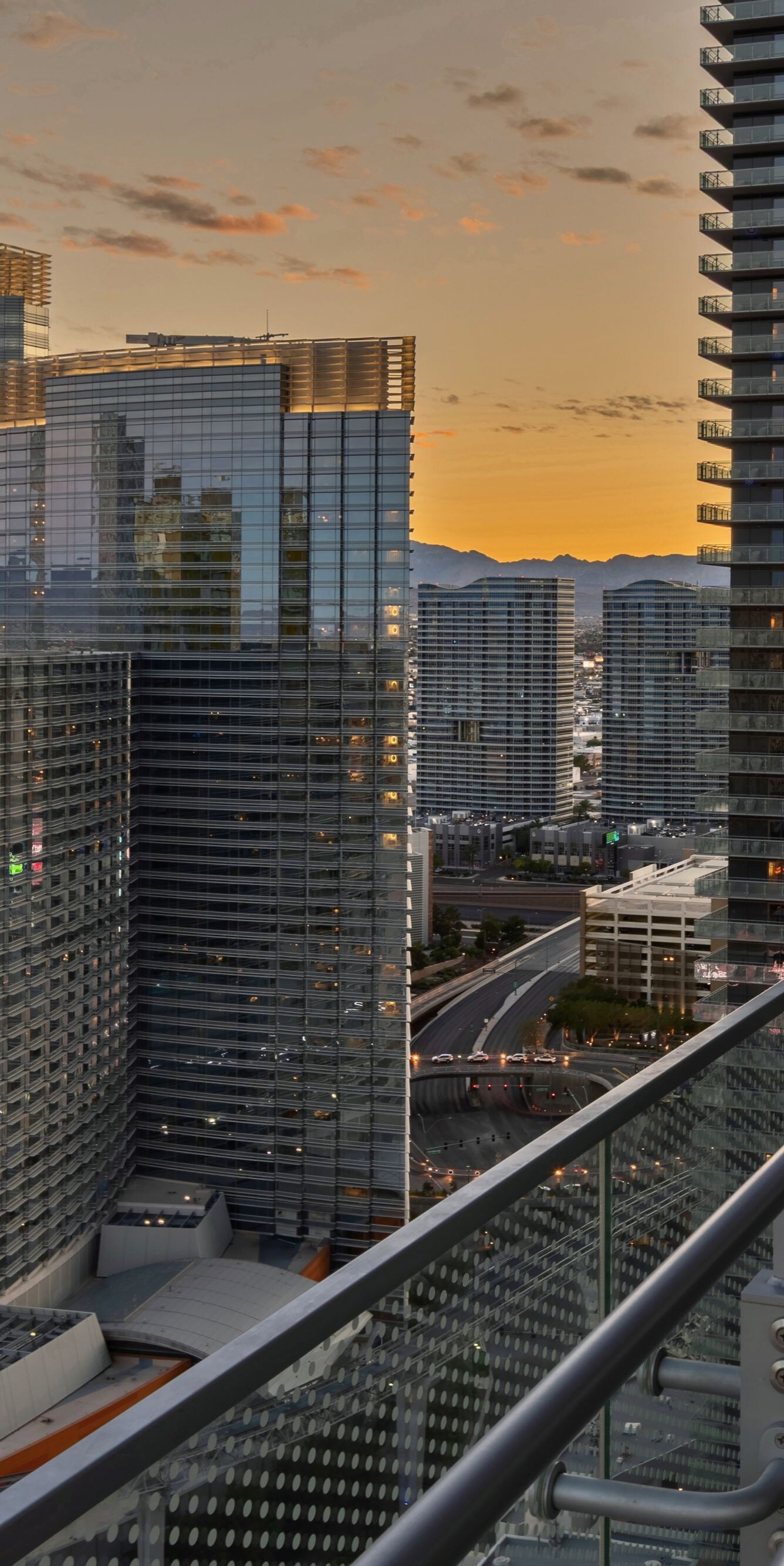 Terrace overlooking ARIA complex, rail, chair.