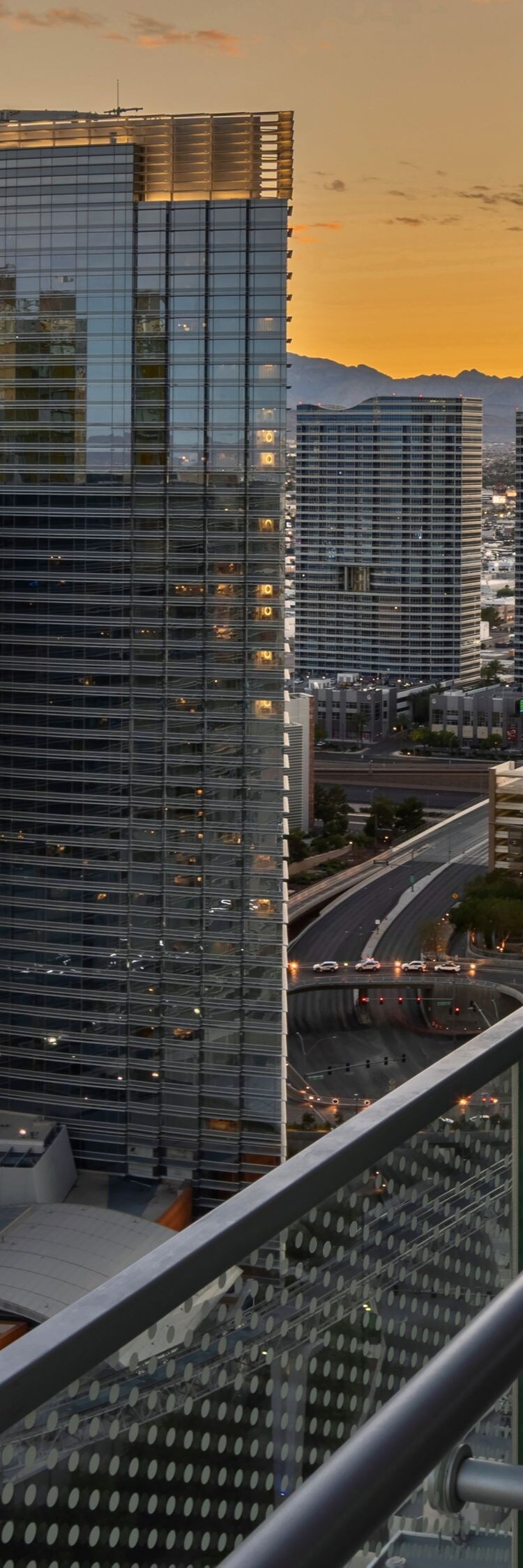 Terrace overlooking ARIA complex, rail, chair.