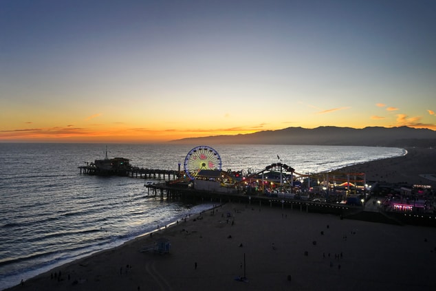 Photo of beach and pier at sunset