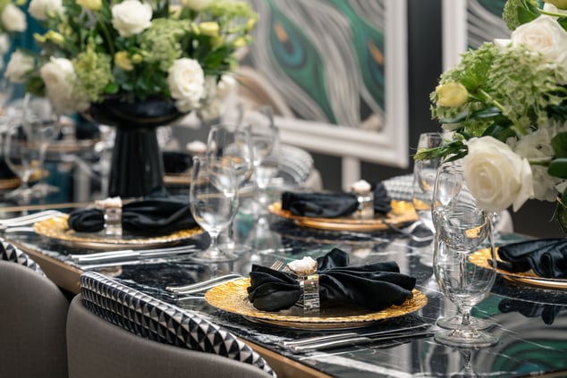 Dining details with gold plates, glasses, florals