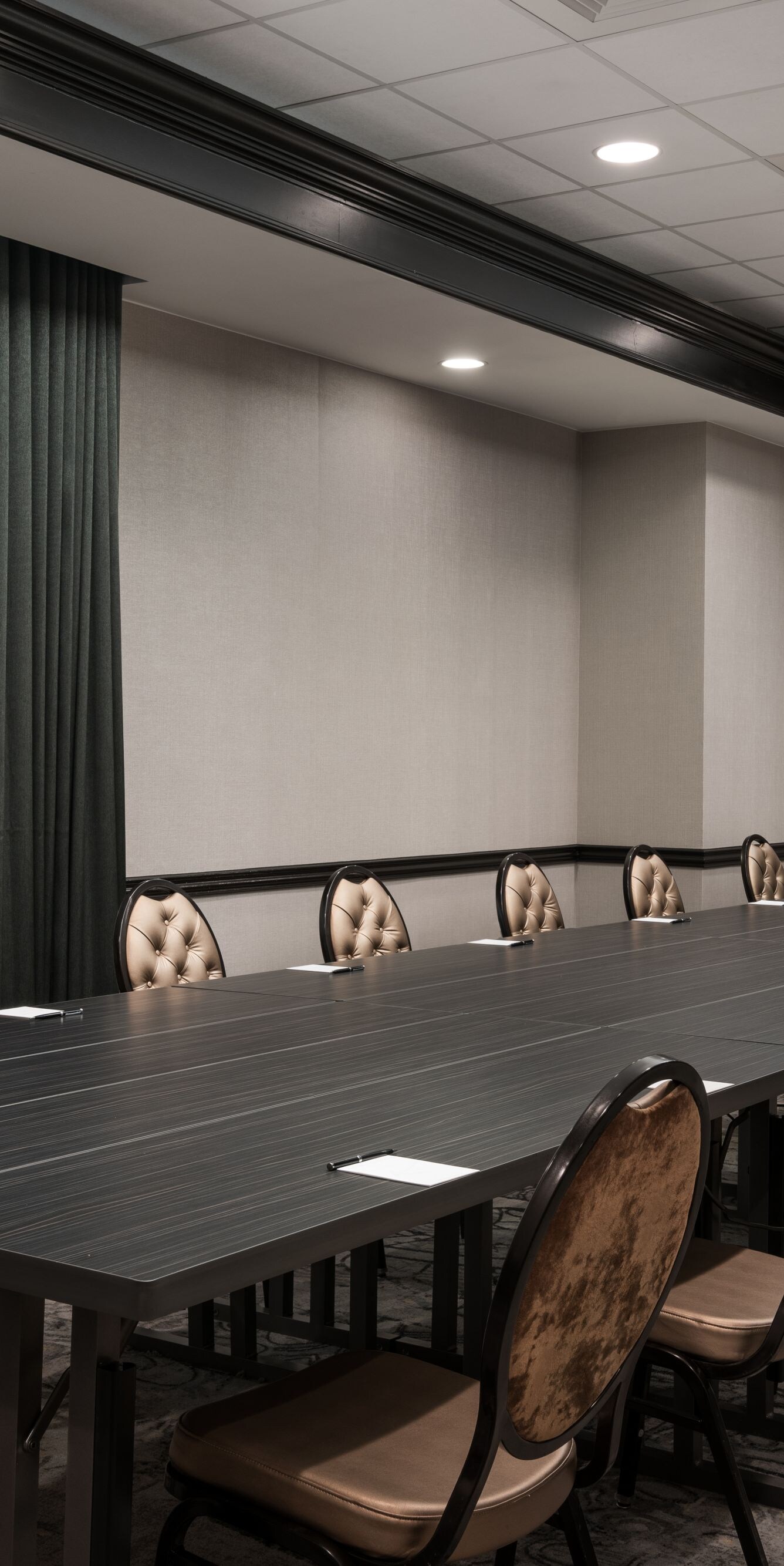 Long table with chairs, window and TV