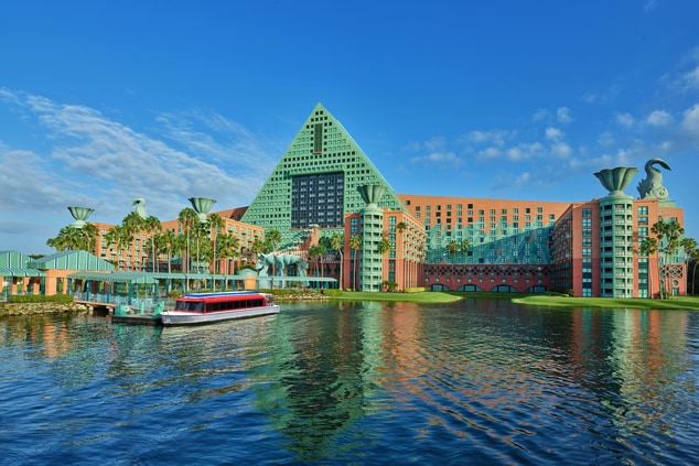 Photo of exterior of hotel with lake and boat 