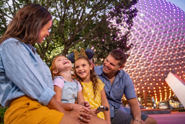 family in front of spaceship earth
