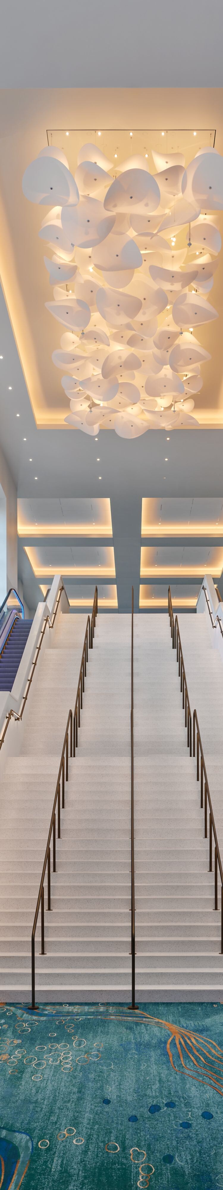 Grand staircase with escalators and chandelier