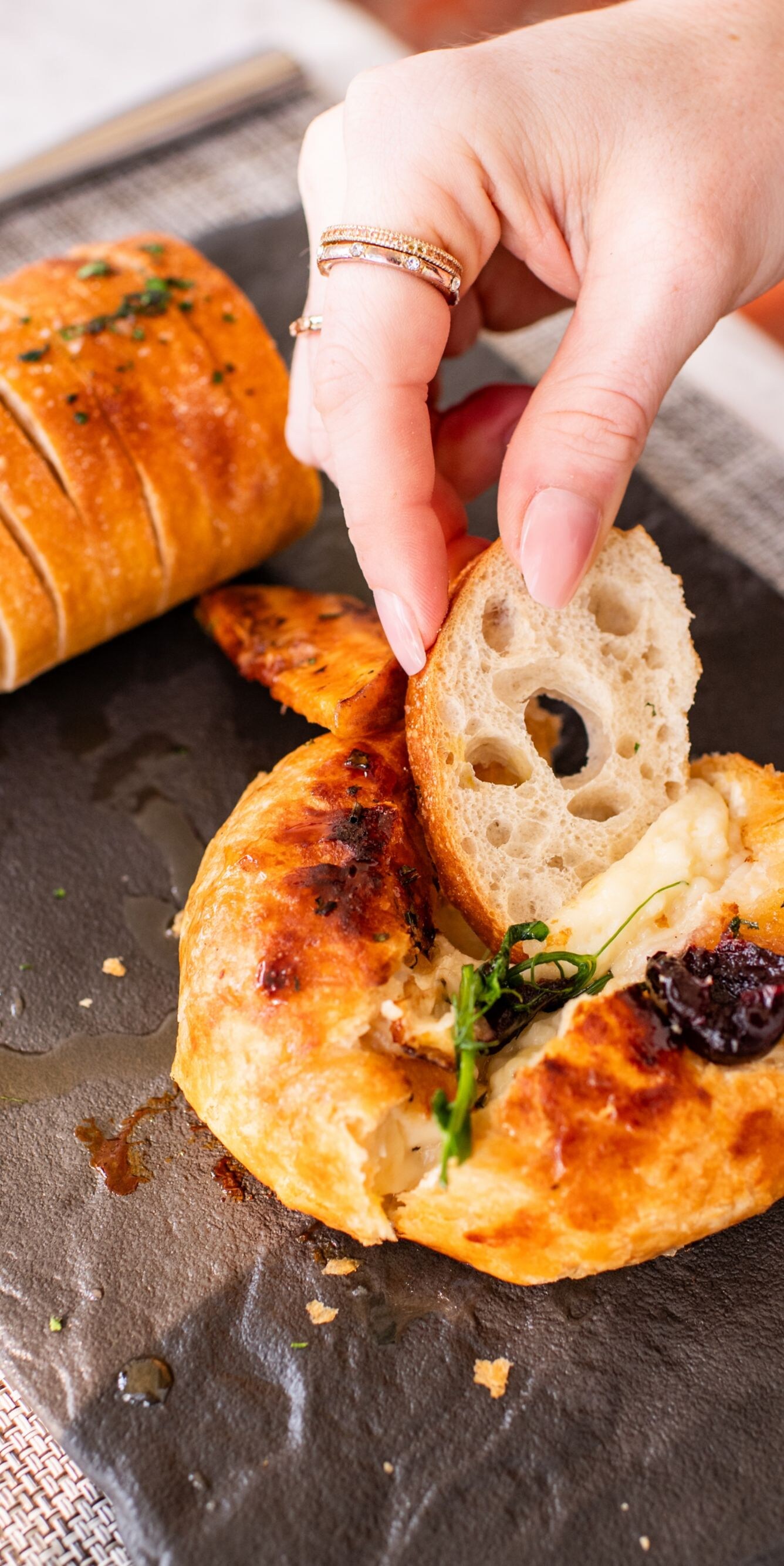 Woman dipping bread in butter