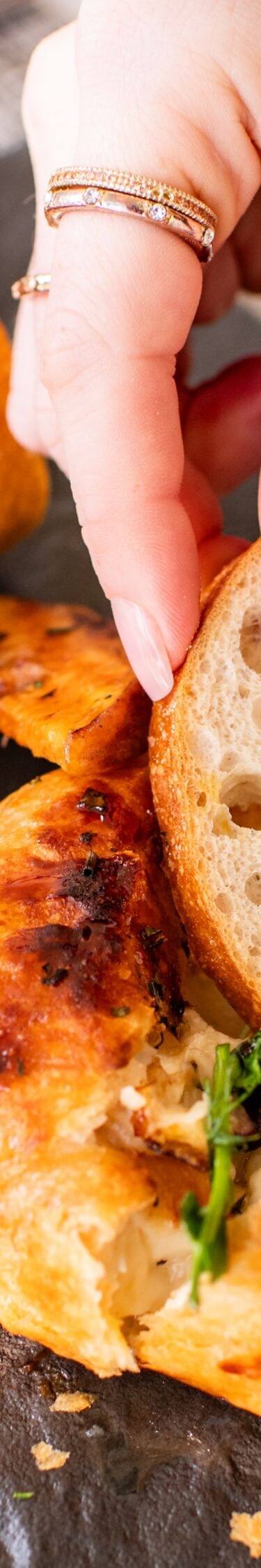 Woman dipping bread in butter