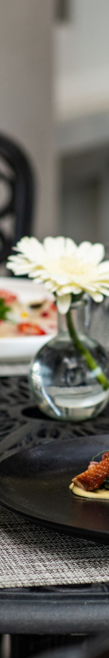 Four dinner plates and wine glasses