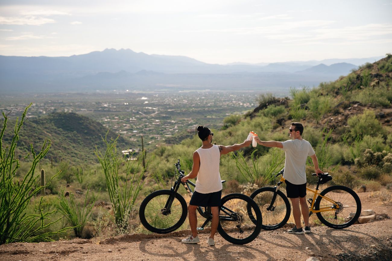 2 men with bikes on trail and views