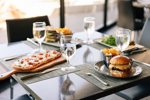 Table set with flatbread pizza and cheeseburger