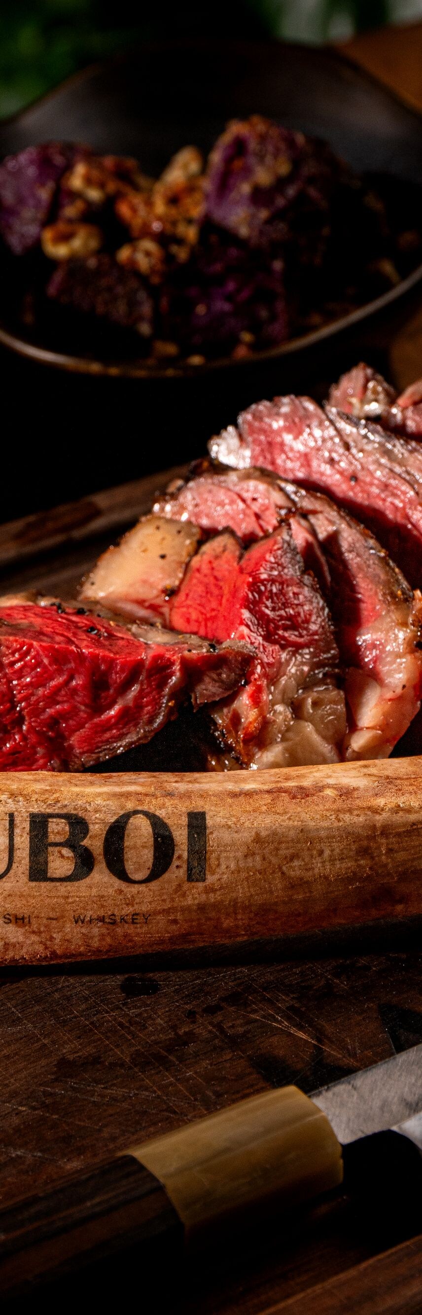 steak served on wooden boat platter