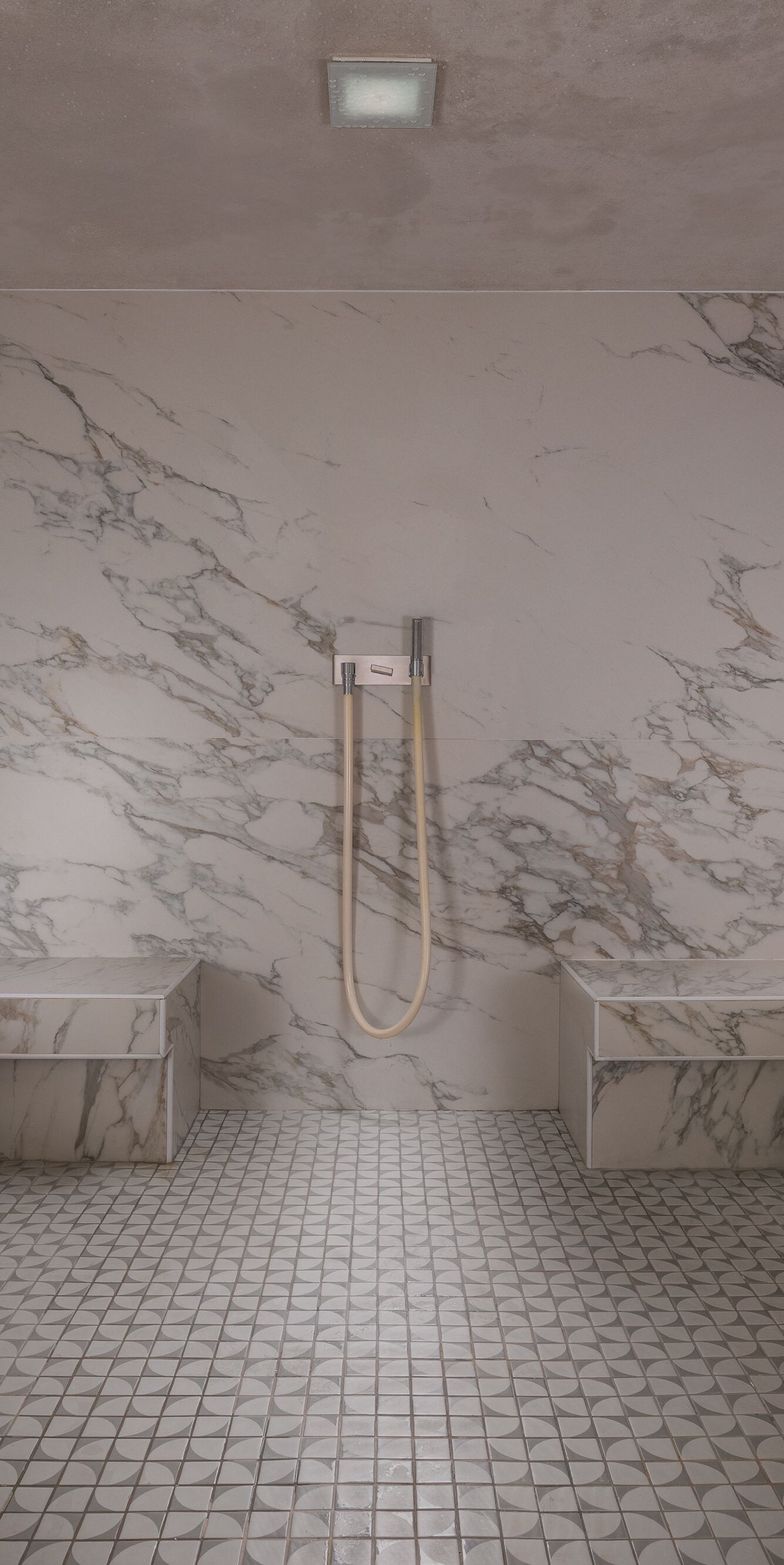 Modern steam room interior with tiled seating