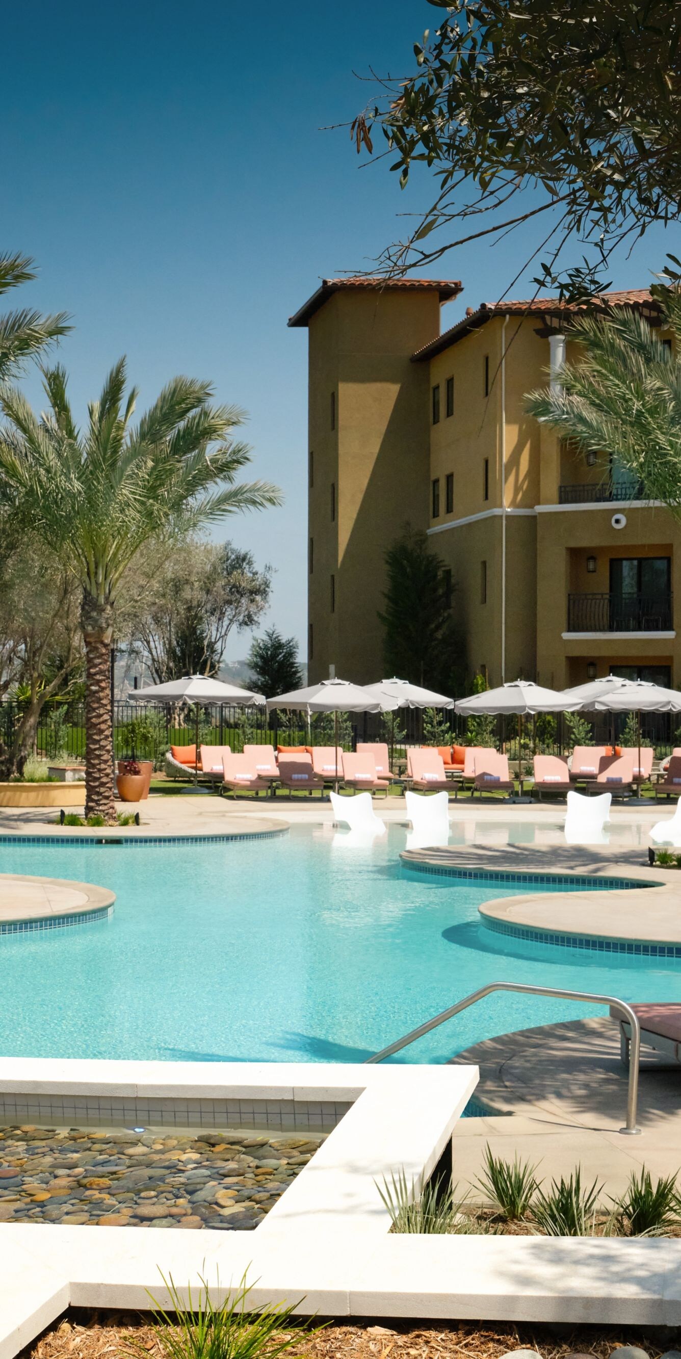Resort pool with palms and lounge chairs