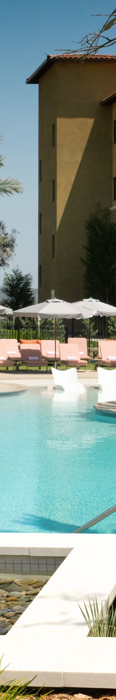 Resort pool with palms and lounge chairs