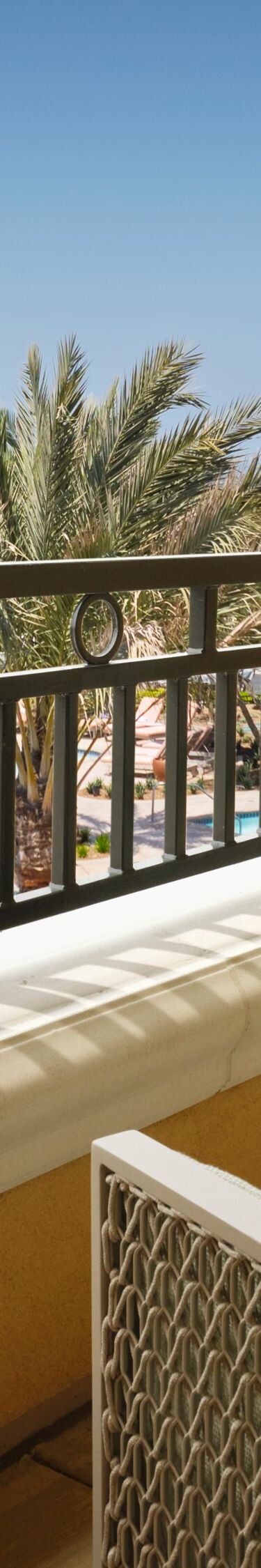 Balcony view of pool and palm trees