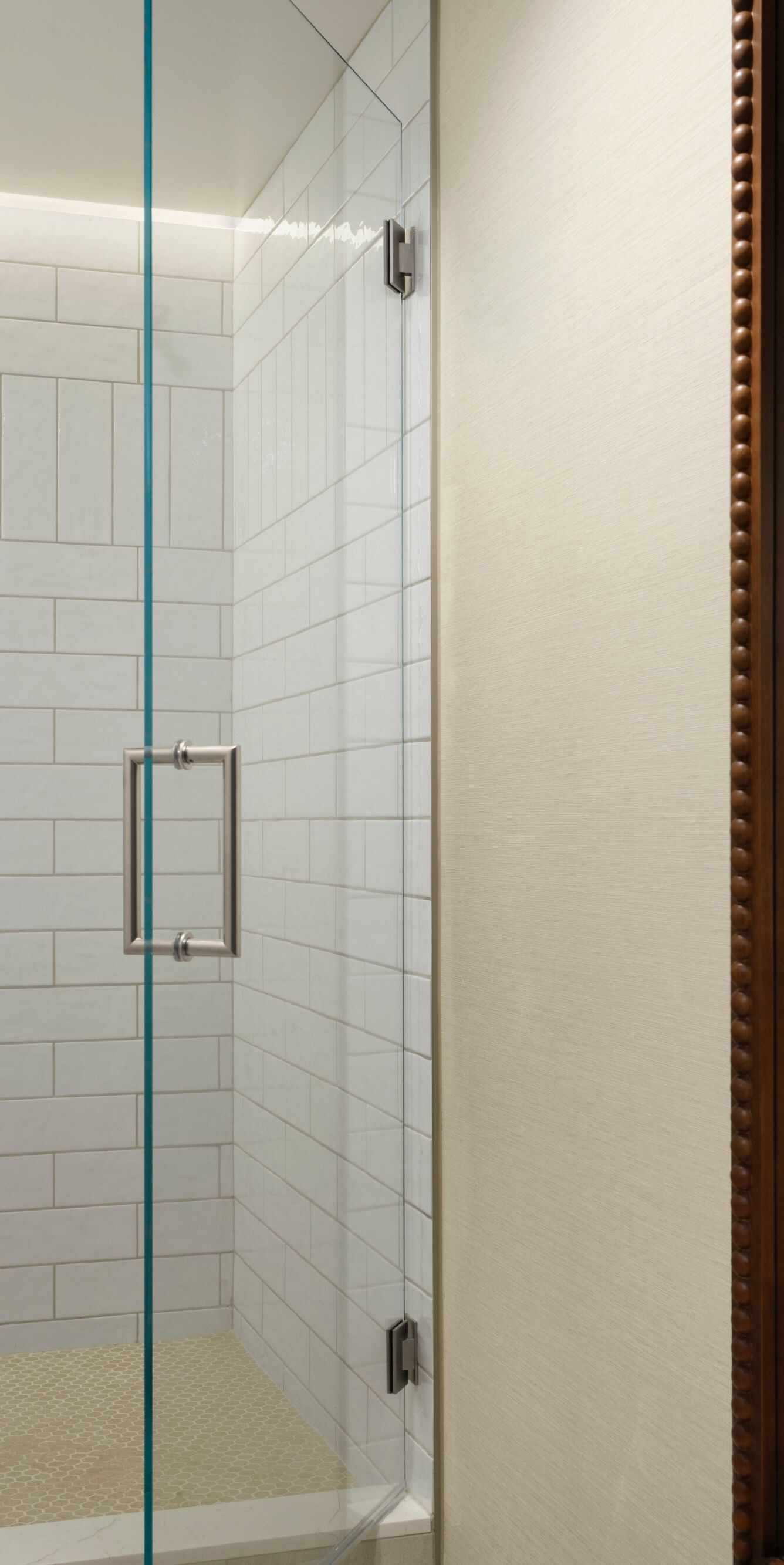 Glass shower with tile walls and toiletries