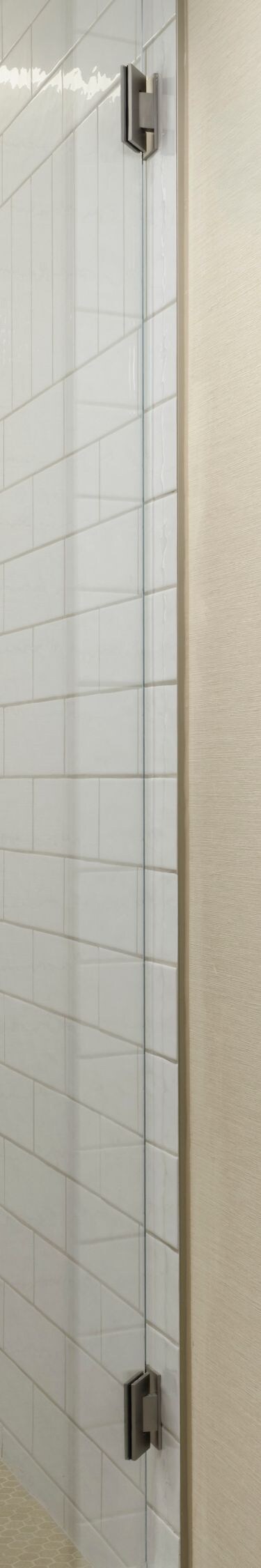 Glass shower with tile walls and toiletries