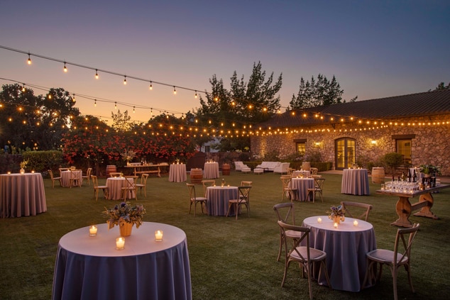 small tables, handing lights, lawn, candles 