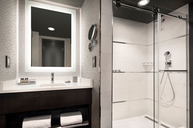 A walk-in shower and a bathroom sink.