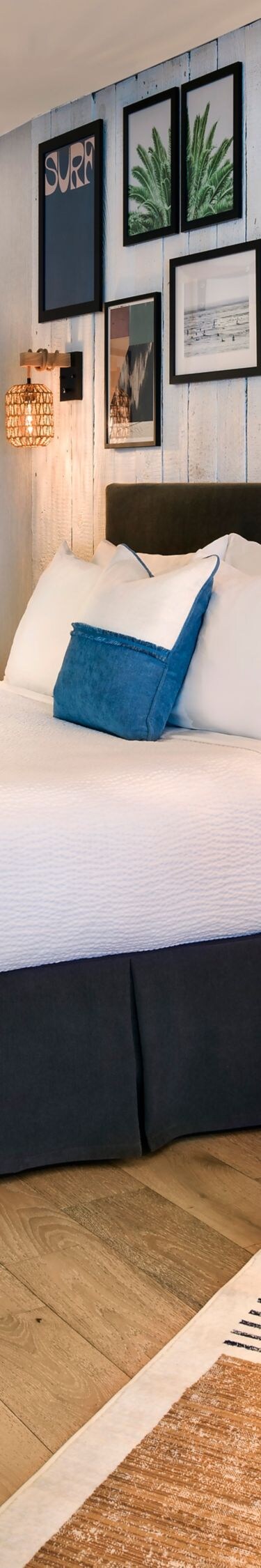 King bed with wall art and open bath area