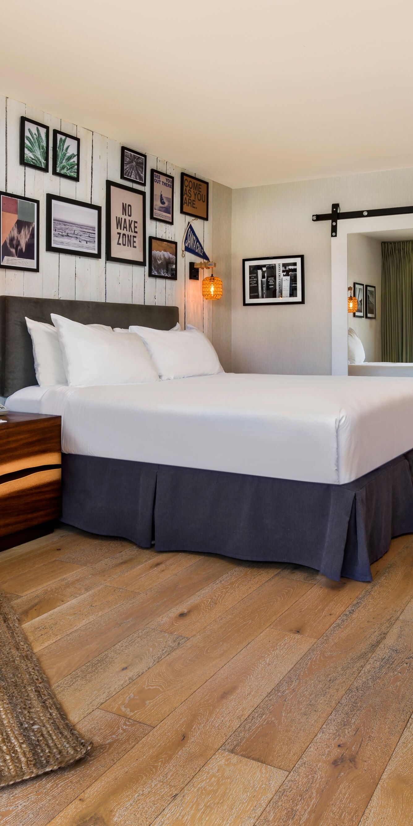 King bed with lounge chair and wall art