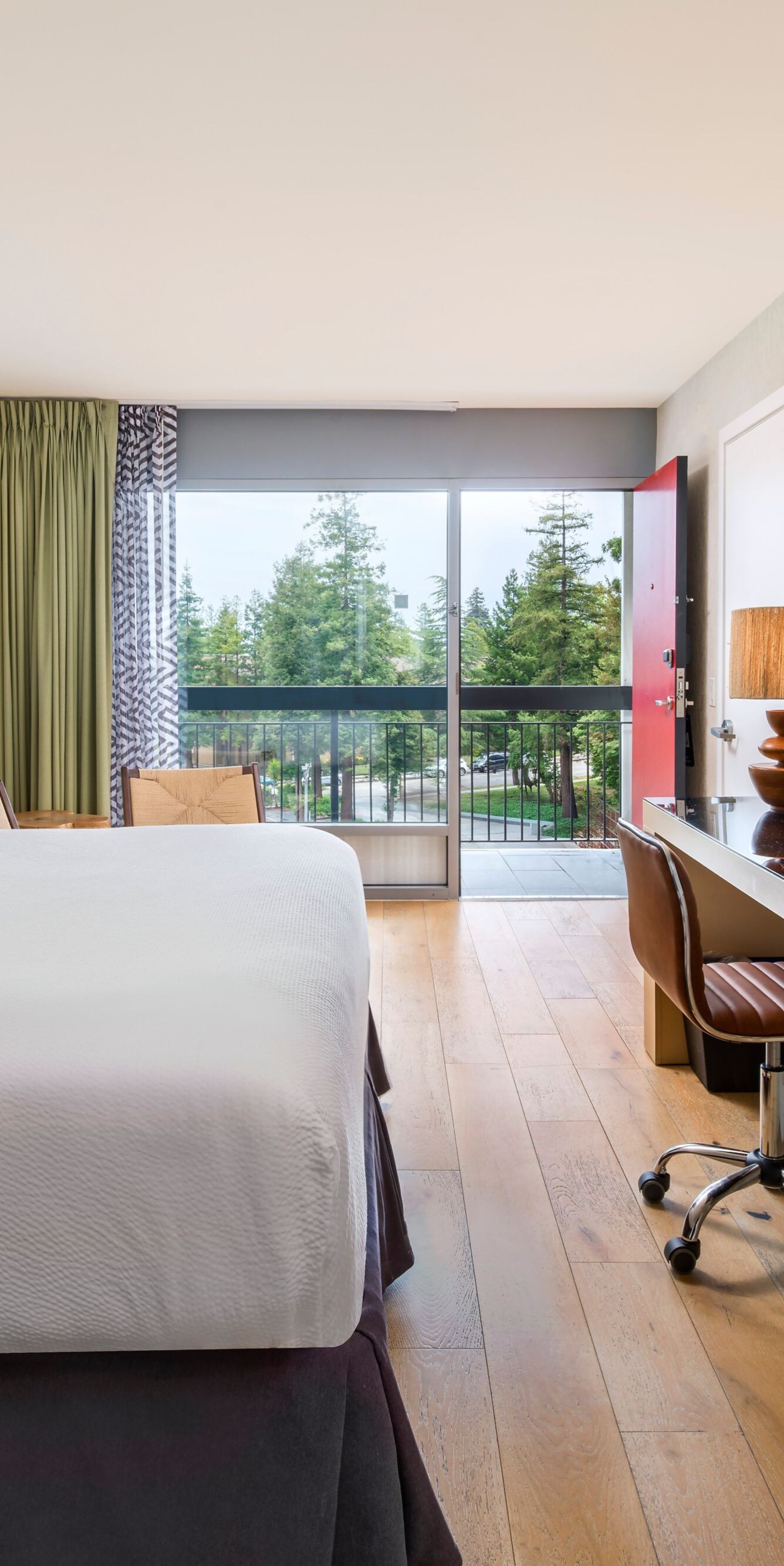 Suite with king bed, desk, tv, and sitting area
