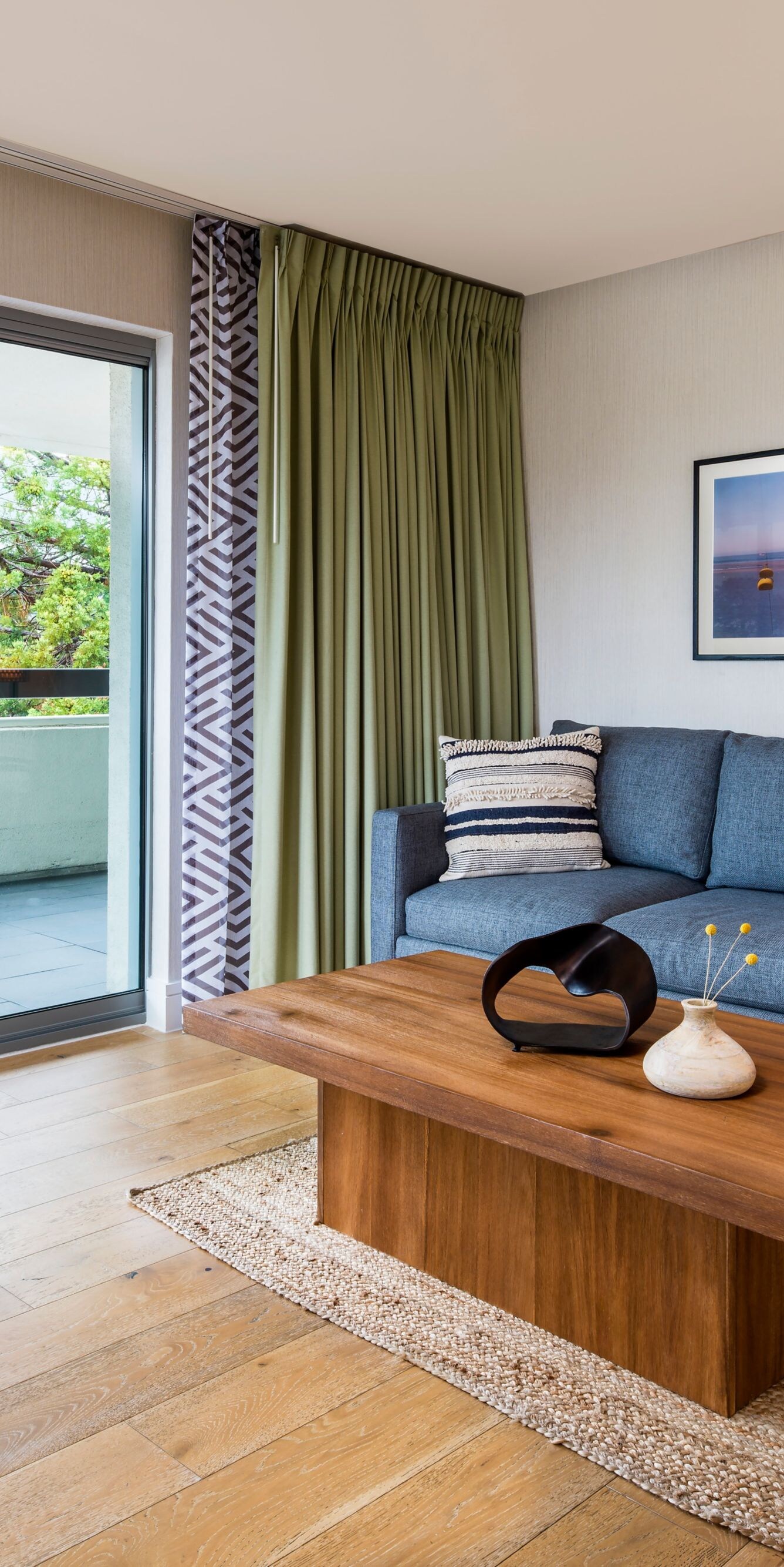 Living area with sofa, chair, and balcony view