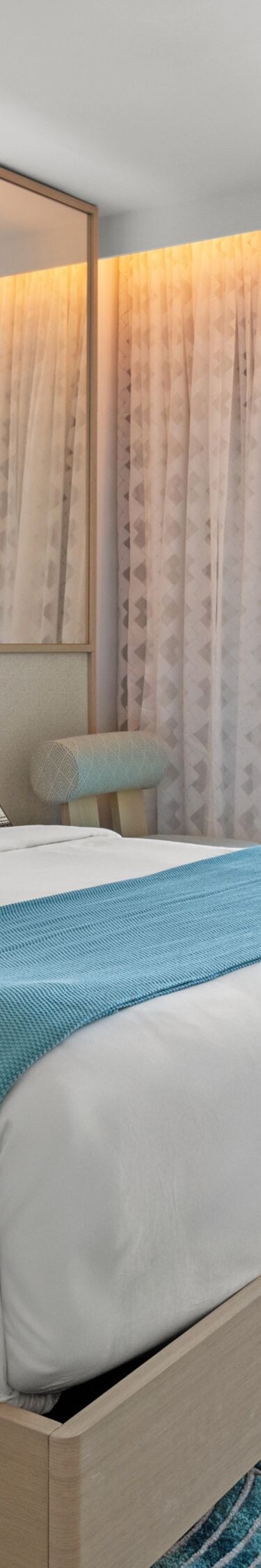 Ocean-view hotel bedroom with hot tub on balcony