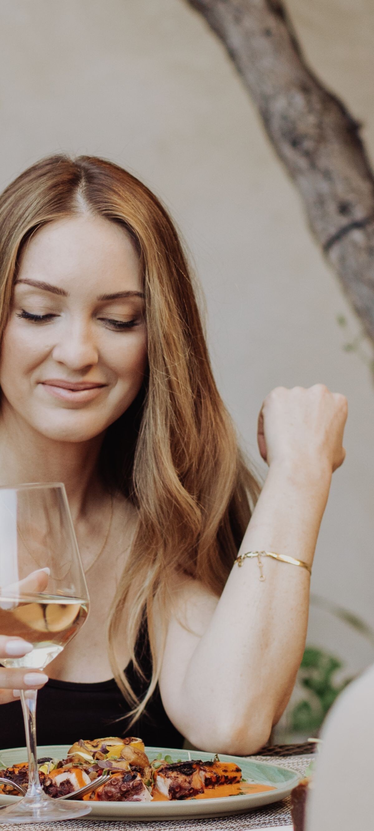 woman smiling while drinking