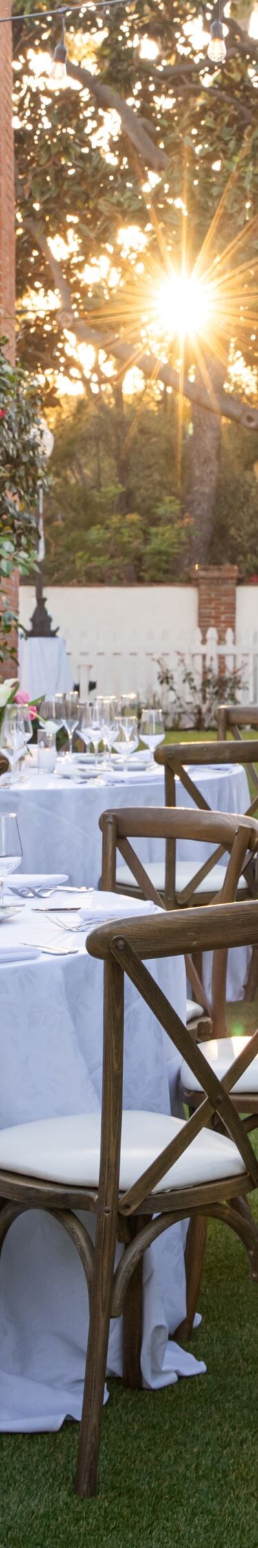 Tables set outdoors for event with decor