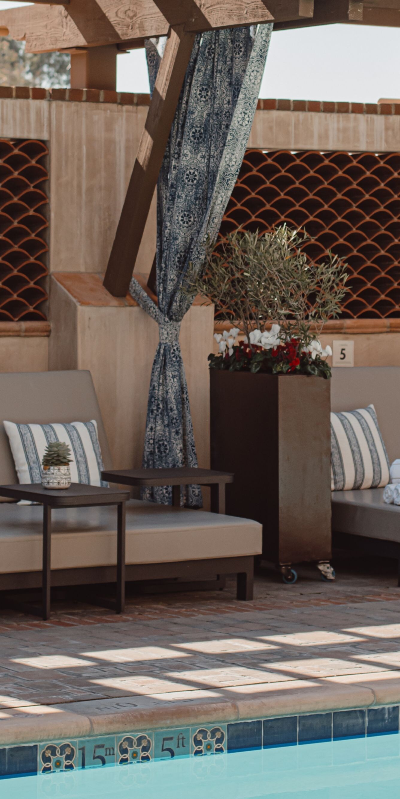 Empty cabana seating with pillows and rolled towel